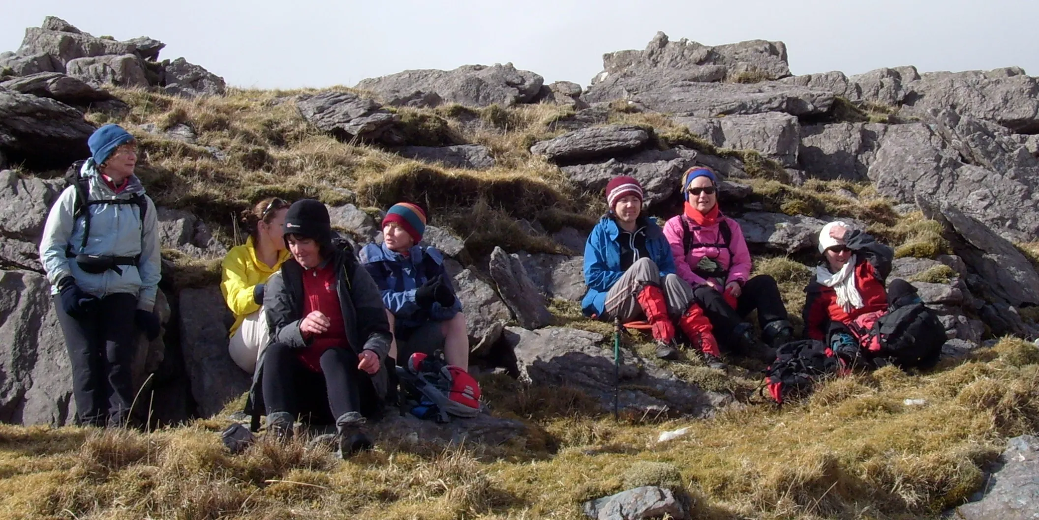 Club members resting among rocks on a hillside on the Kerry Way
